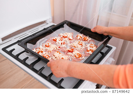 Chops. Woman hands put fresh turkey steaks meat on oven tray Chops. Woman hands put fresh turkey steaks meat on oven tray 87149642