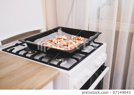 Woman hands put fresh turkey steaks meat on oven tray Woman hands put fresh turkey steaks meat on oven tray 87149643