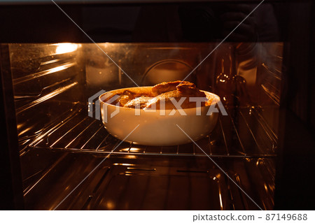 Chicken baked in the oven in a glass pan. Homemade food. 87149688