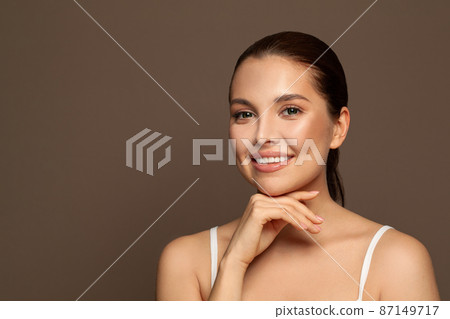 Attractive spa model woman with healthy clear skin and cute smile. Attractive spa model woman with healthy clear skin and cute smile. 87149717