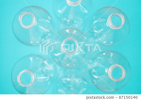 Empty plastic bottles on green background for recycling. Top view, copy space. Plastic waste background. Empty plastic bottles on green background for recycling. Top view, copy space. Plastic waste background. 87150140