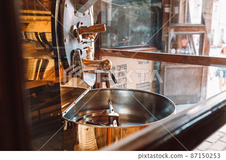 Empty modern roasted cooler professional machines for fresh brown coffee beans movement close up at factory Empty modern roasted cooler professional machines for fresh brown coffee beans movement close up at factory 87150253