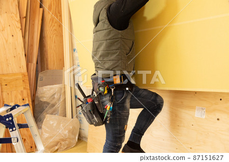 Craftsman at the construction site of a new detached house Craftsman at the construction site of a new detached house 87151627