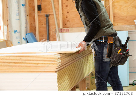 Craftsman at the construction site of a new detached house 87151768