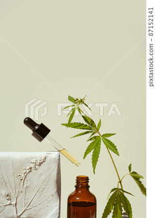 CBD oil in pipette and open bottle with leaf marijuana, 87152141