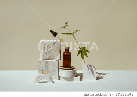 CBD oil in pipette, open bottle with leaf marijuana CBD oil in pipette, open bottle with leaf marijuana 87152142