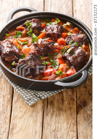 Spanish Bull Tail Stew Rabo De Toro closeup on a pot on the table. Vertical Spanish Bull Tail Stew Rabo De Toro closeup on a pot on the table. Vertical 87152173