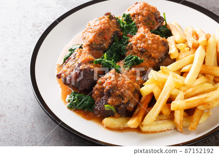 Tasty Rabo de toro or oxtail stew served with french fries on white plate on the table. Horizontal 87152192