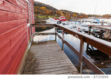Norwegian fishing village view, wooden barns 87153050