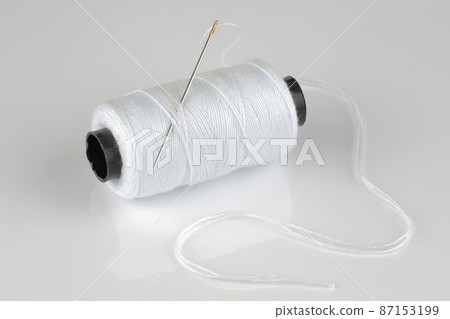 white cotton reel and needle with reflection white cotton reel and needle with reflection 87153199