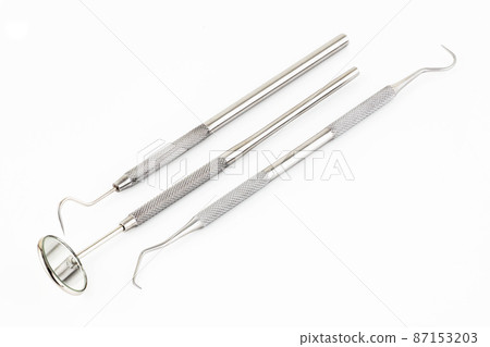 Dental mirror scaler and sickle probe explorer tools on white background 87153203