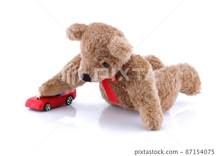 Teddy bear playing with his toy car Teddy bear playing with his toy car 87154075