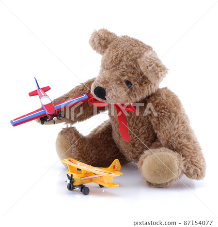 Small cute teddy playing with toy planes Small cute teddy playing with toy planes 87154077