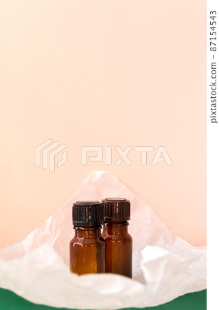 Aroma oil glass bottle with torn paper, skin care products Aroma oil glass bottle with torn paper, skin care products 87154543