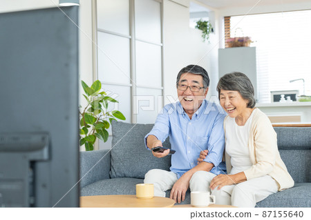 Senior couple watching tv Senior couple watching tv 87155640