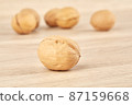 Walnuts on a wooden background, one nut in the foreground 87159668