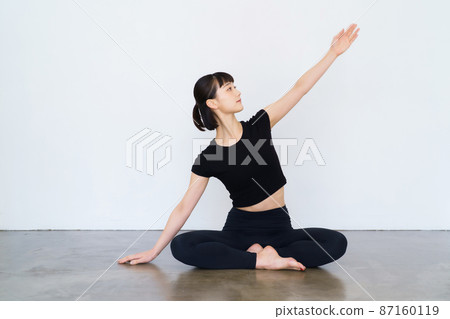 Women doing yoga and flexibility exercises 87160119