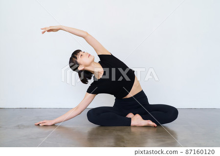 Women doing yoga and flexibility exercises 87160120