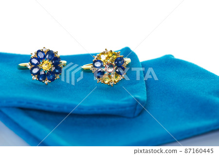 Blue and yellow sapphire Jewel or gems ring on velvet bag. Collection of natural gemstones accessories. Studio shot 87160445