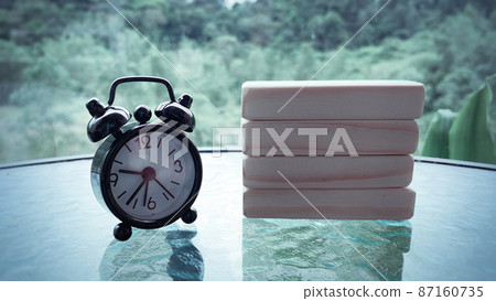 Black alarm clock with wooden blocks background. Copy space Black alarm clock with wooden blocks background. Copy space 87160735