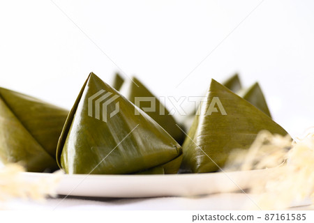 Thai dessert (Khanom Tian), Sweet dough pyramid stuffed with coconut wrapped by banana leaf 87161585