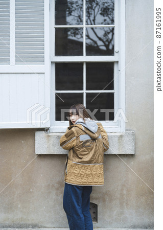 A woman walking around a tourist spot 87161995