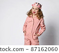 playful girl in a cotton pink summer jumpsuit and 87162060