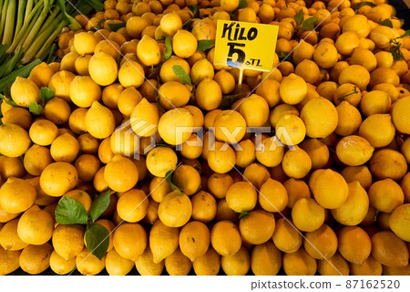 Fresh Sicilian lemons at food street market citrus fruit background. 87162520