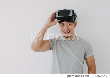 Happy man present virtual glasses application for metaverse technology. Happy man present virtual glasses application for metaverse technology. 87162647