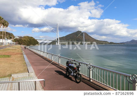 View of Tatara Bridge and Ikuchi Island from Shimanami Kaido Omishima Road Station 87162696