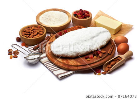 Traditional Christmas stollen cake with recipe ingredients isolated on white background Traditional Christmas stollen cake with recipe ingredients isolated on white background 87164078
