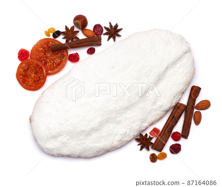 Traditional Christmas stollen cake with marzipan and dried fruit isolated on white background Traditional Christmas stollen cake with marzipan and dried fruit isolated on white background 87164086