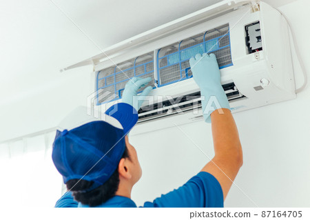 Men in work clothes cleaning air conditioners and air conditioning equipment (back view) 87164705