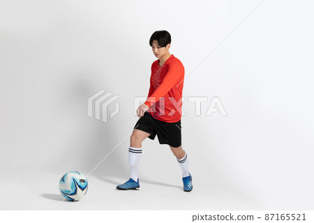 soccer football sports player, asian korean man with motions in studio background 87165521