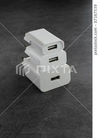 Three phone or tablet chargers on dark background 87167539