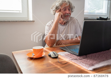 Senior man connecting with his family via video call 87168478