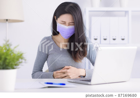 Young woman suffering from abdominal pain office Young woman suffering from abdominal pain office 87169680