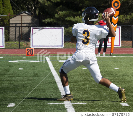 Football quarterback passing the ball during a game Football quarterback passing the ball during a game 87170755