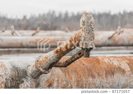 Old steel rusty abandoned pipes of the water cooling pipeline system of the combined heat and power industrial plant 87171057