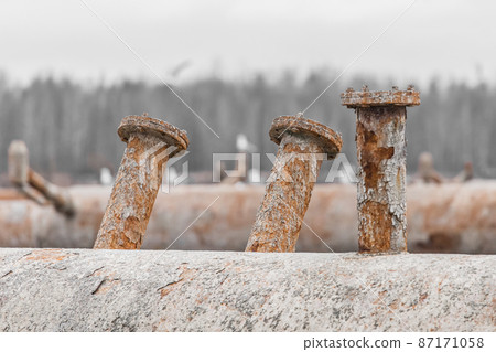 Old steel rusty abandoned pipes of the water cooling pipeline system of the combined heat and power industrial plant 87171058