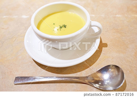 Corn soup in a cup and a spoon placed in front Corn soup in a cup and a spoon placed in front 87172016
