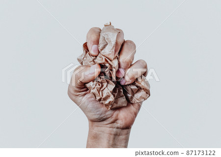 man squeezing a ball of paper man squeezing a ball of paper 87173122