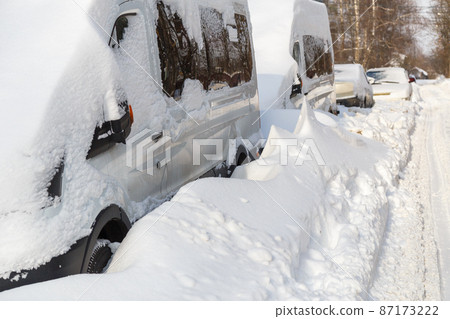 close-up view on snow-covered cars at sunny winter morning 87173222