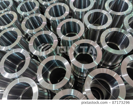 abstract industrial shiny steel production stack background with cnc machined pipes - selective focus and lens blur technique abstract industrial shiny steel production stack background with cnc machined pipes - selective focus and lens blur technique 87173296