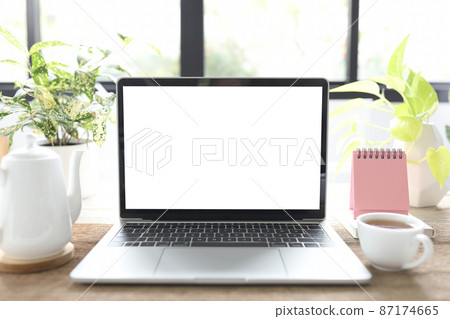 Laptop and coffee cup and mini calendar Laptop and coffee cup and mini calendar 87174665