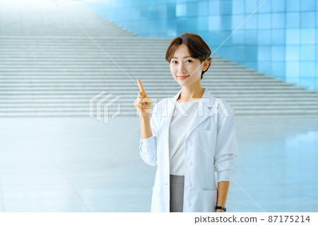 Smiling female doctor in a white coat at the hospital 87175214