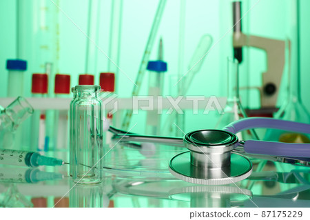 Stethoscope on Chemical Lab - Labs Photo in Green Colors Stethoscope on Chemical Lab - Labs Photo in Green Colors 87175229