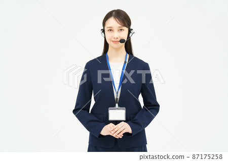 A woman in a suit wearing a headset 87175258