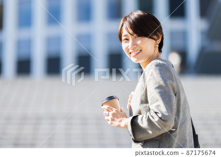 Woman with takeaway coffee Woman with takeaway coffee 87175674