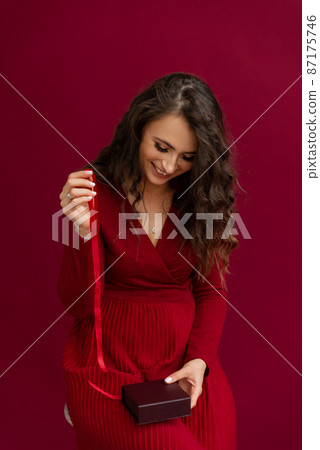 Positivity emotional woman in red dress opened box with stripe 87175746